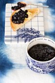 Blueberry jam in a pot and on a slice of toast
