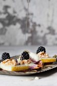 Manchego with bread chips, walnuts, blackberries and honey
