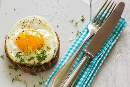 A fried egg on toast with cress