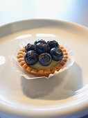 A shortcrust tartlet with lemon and mascarpone cream and blueberries