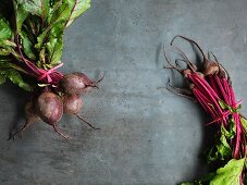Two bunches of beetroot on a grey surface