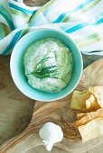 Tzatziki in a bowl with unleavened bread