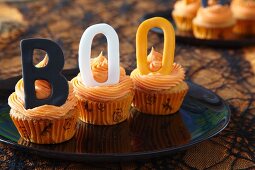 Halloween cupcakes decorated with buttercream icing and decorative letters