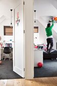 Foyer with open doors and view of teenager in bedroom next to open-plan study