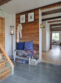 Entrance hall in old, Swedish wooden house with white-clad sections of wall and ceiling