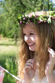Young girl wearing wreath of purple clover