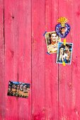 Old Mexican photos on wooden wall painted red