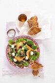 Spinach salad with pomegranate seeds, caramelised pear crisps and Brie