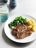 Herb steak with a pea and asparagus medley and potatoes