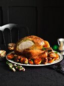 Carved roast turkey with a herb and pistachio filling and side dishes