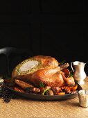 Carved roast turkey with a herb and pistachio filling and side dishes