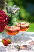 Two glasses of strawberry Prosecco with lavender flowers