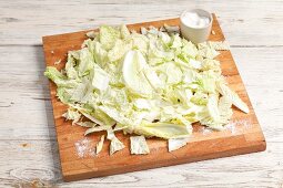 Sliced Chinese cabbage with salt on a chopping board