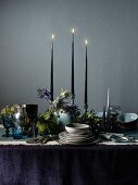 A festive table decorated in dark blue tones