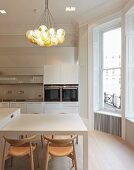 Private Apartment, London, United Kingdom. Architect: Hill Mitchell Berry, 2014. Modern kitchen with designer wooden chairs and spherical pendant lamps