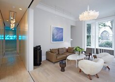 Private Apartment, London, United Kingdom. Architect: Hill Mitchell Berry, 2014. Open-plan living room with extravagant armchairs and white coffee table