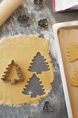 Christmas trees cut out of shortbread pastry with a cutter