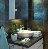 Mirrored cabinet above washstand with countertop basin against dark, iridescent wall tiles