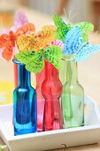 Butterfly decorations in colourful bottles on tray