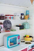 Colourful, retro play kitchen in Scandinavian playhouse