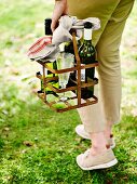 Woman carrying bottle basket with wine