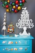 Stylised Christmas tree on pale blue chest of drawers