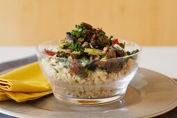 Rice salad with Portobello mushrooms, roasted peppers, dried tomatoes, kale and walnuts