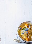 Braised sauerkraut with apricots and borage flowers