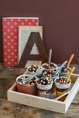 Chocolate mousse with chocolate pearls in paper cups