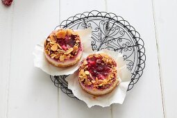 Raspberry tartlets with almonds on paper