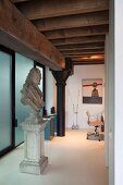 Baroque-style bust on plinth in loft apartment