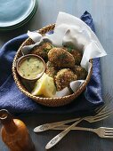 Crab cakes with a dip in a basket