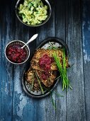 Herrings in a nut crust with cranberries and broccoli and potato mash