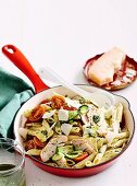 Penne with chicken, tomatoes, brie and rocket pesto in pan