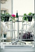 Stainless steel outdoor chairs at bistro table on balcony