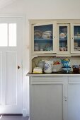 Vintage-style crockery on and in white-painted kitchen dresser