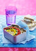 A lunchbox filled with grains and vegetables