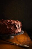 A chocolate cake on a slate cake stand