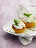 Grilled peaches with ice cream, lime zest and lemon balm