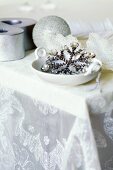 Glittering Christmas decorations on silk organza tablecloth by Carolyn Quartermaine