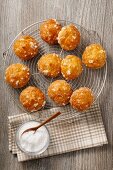 Chouquettes with sugar crystals on a cooling rack
