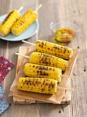 Grilled corncobs with garlic and chilli olive oil