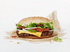 A cheeseburger on a piece of paper