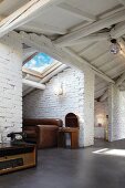 Niches with whitewashed brick walls under white-painted roof structure in loft apartment with vintage furnishings