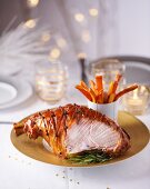 Christmas ham with cloves and rosemary, sliced
