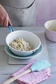 Cooked barley being drained in a sieve