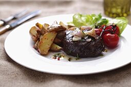 Rump steak with potato wedges and cherry tomatoes