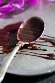 Chocolate sauce on a silver spoon