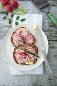 Slices of bread topped with radishes