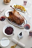 Roast Christmas goose with red cabbage, dumplings, gravy and red wine